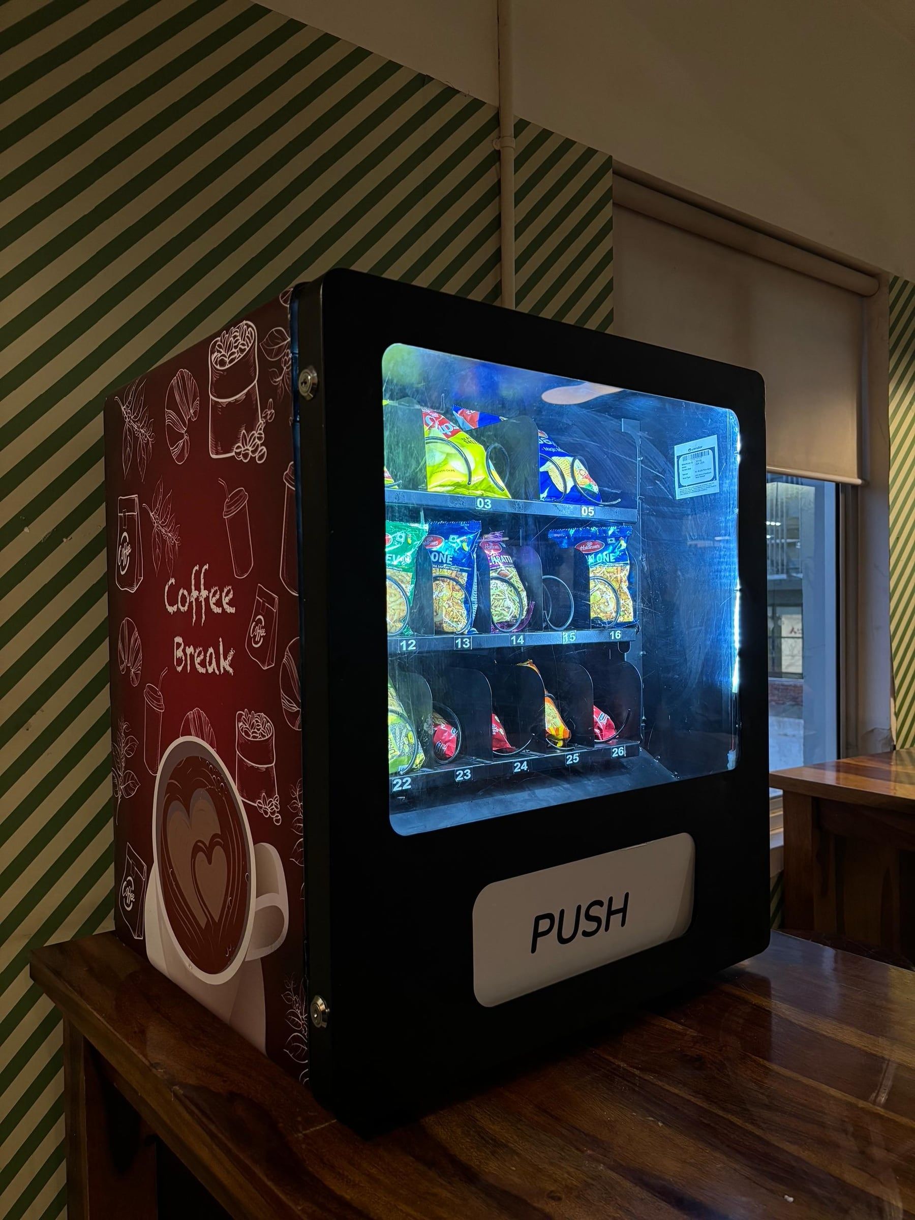 A Wendor Comet countertop machine next to a coffee machine in an office pantry