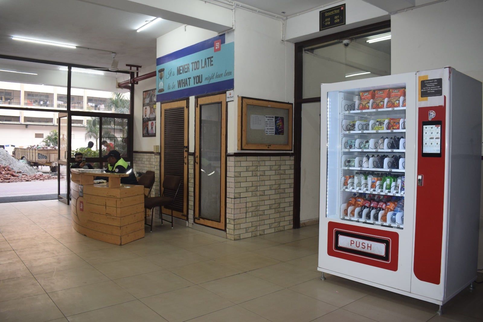 A white Wendor machine in an institute reception area