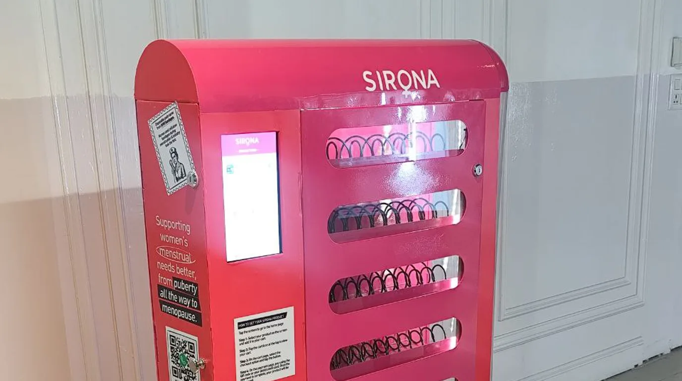 Finger selecting a product on a glowing vending machine touchscreen